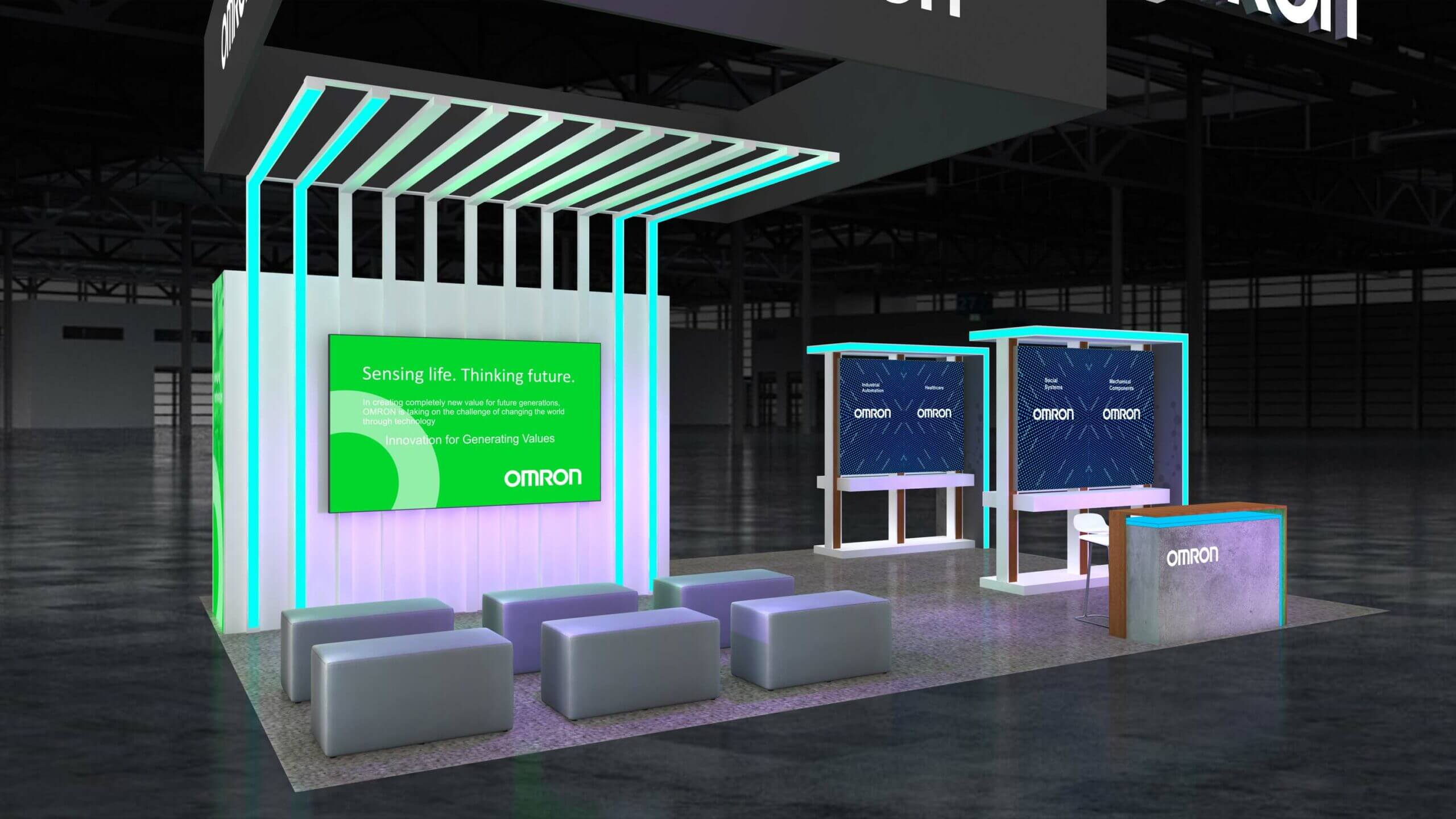 Omron booth with illuminated turquoise ceiling ribs, a large screen and a gray lounge seating area.