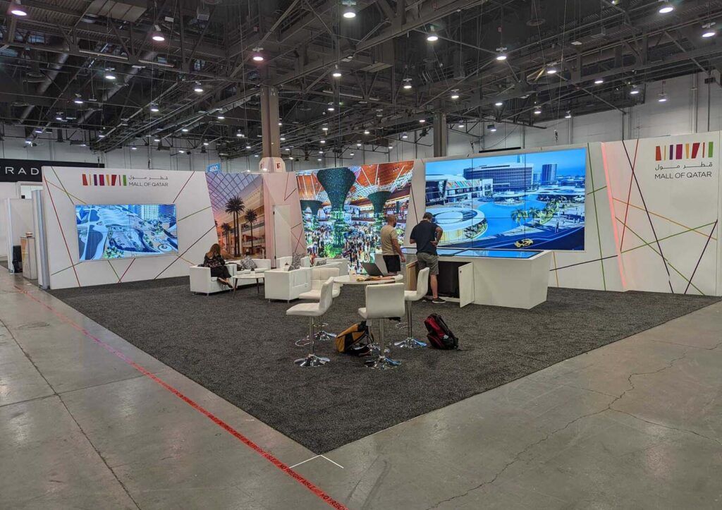 Mall of Qatar completed booth: a panoramic wall of mall photographs surrounding lounge seating