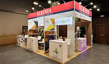 AL -International Trade Centre completed booth: a rectangular canopy framing product displays and reception counters