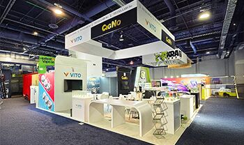 TFI Labs Inc completed booth: a rectangular hanging sign above product counters and meeting tables