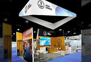 Port Gdansk completed booth: a large rectangular hanging sign above graphic panels and display counters