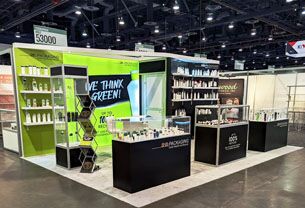 SHB completed booth: product shelves around a prominent graphic wall and reception counter