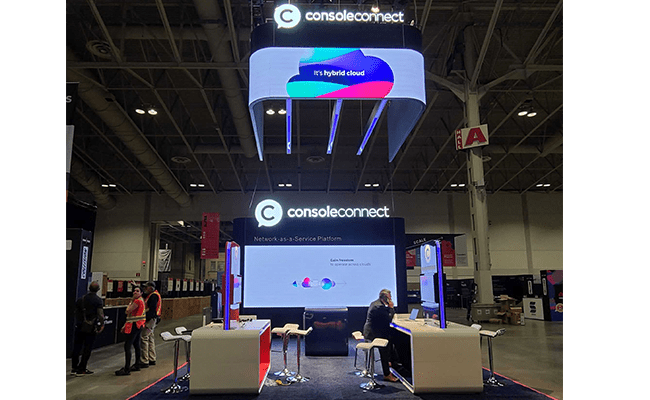 Console Connect completed booth: front view of the reception counter and branded tower beneath the illuminated overhead sign