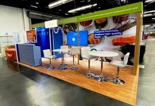 Galactic completed booth: a long graphic wall above a counter lined with bar stools