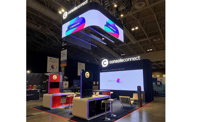 Console Connect completed booth: angled view of the video displays and counters beneath an illuminated overhead sign