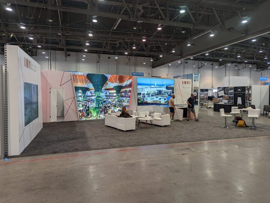 Mall of Qatar completed booth: a panoramic wall of mall photographs surrounding lounge seating