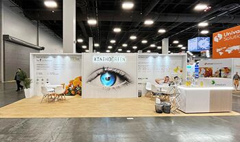 Ennature Biopharma completed booth: a wide graphic back wall behind product displays and meeting tables