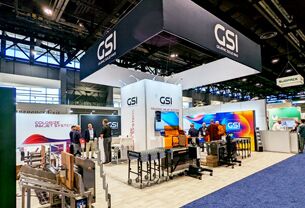 GSI completed booth: a large rectangular hanging sign above display walls and reception counters