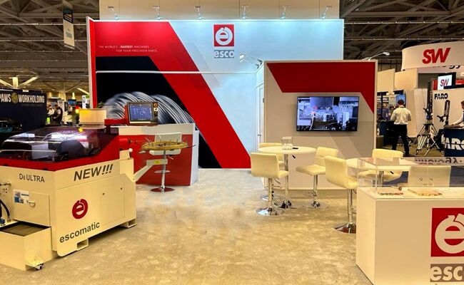 ESCO completed booth: an angled graphic wall beneath a long rectangular hanging sign