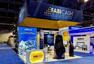 Fabicash completed booth: a rectangular hanging sign above demonstration stations and reception counters