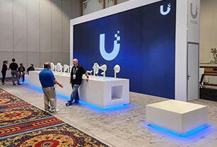UI completed booth: a broad back wall with a reception desk across the open front
