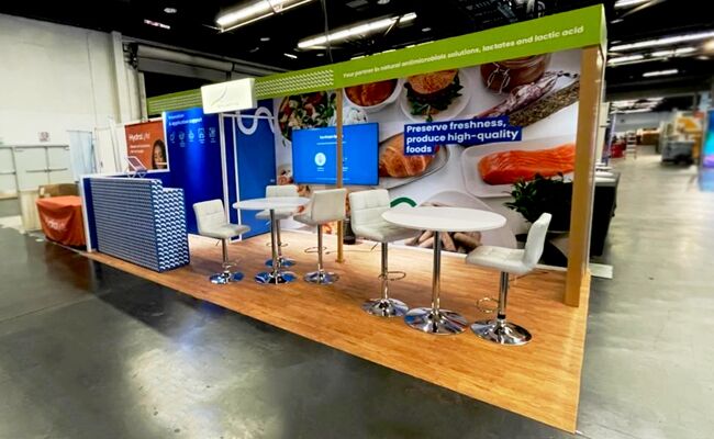 Galactic completed booth: a long graphic wall above a counter lined with bar stools