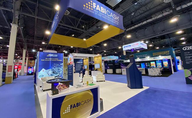 Fabicash completed booth: a large rectangular hanging sign above demonstration stations and counters