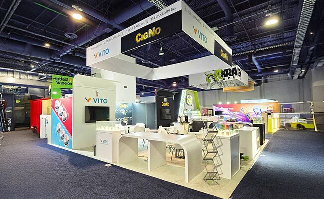 TFI Labs Inc completed booth: a rectangular hanging sign above product counters and meeting tables