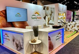 Rabbex LLC completed booth: tiered display walls with floral graphics, a front counter and a round table