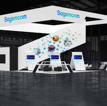 Sagemcom booth with a white square hanging sign, a sloping illustrated display wall and demonstration counters.