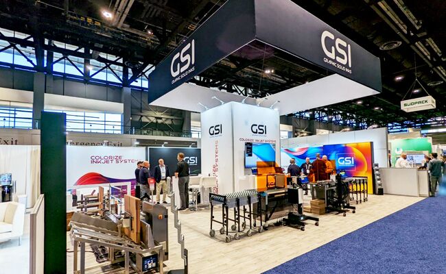 GSI completed booth: a large rectangular hanging sign above display walls and reception counters