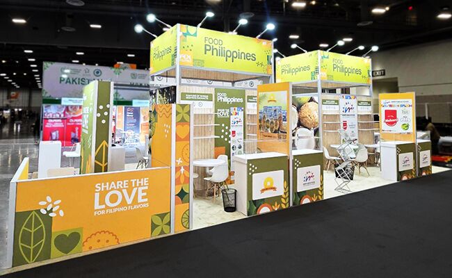 Philippines Pavilion (CITEM) completed booth: a pavilion canopy above multiple display kiosks and reception counters