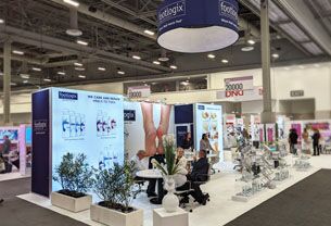Footlogix completed booth: a circular hanging sign above product shelves, graphic panels and seating