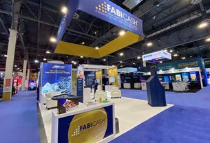Fabicash completed booth: a large rectangular hanging sign above demonstration stations and counters