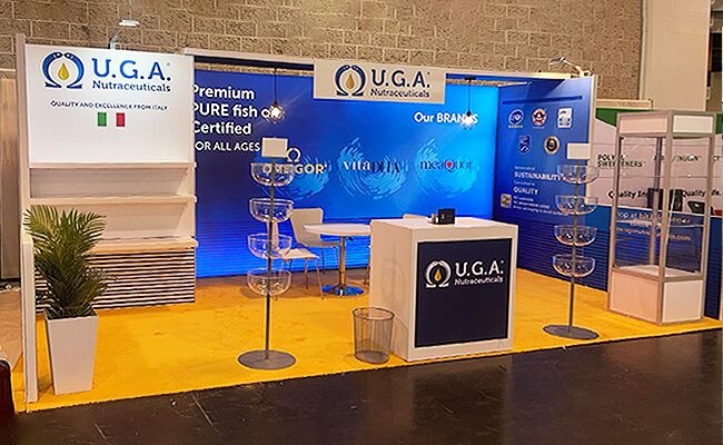 UGA Nutraceuticals completed booth: a graphic back wall between slatted display panels, with a counter and table