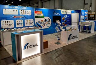 Royal Composites completed booth: wall-mounted product samples behind a long reception counter
