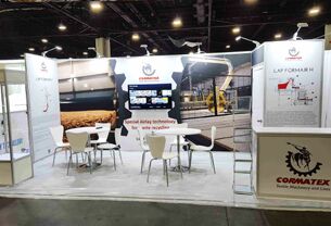 Cormatex completed booth: product samples mounted on wall panels around a central meeting area