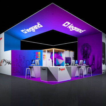 Legrand booth with a large square canopy, illuminated purple walls and product display counters.