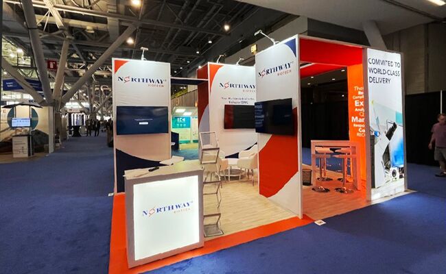 Northway Biotech completed booth: angled display walls around a screen, reception desk and meeting tables