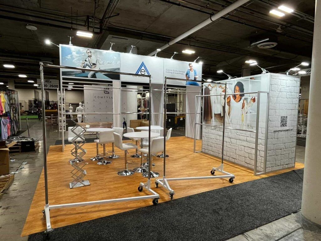 Empire Apparels completed booth: rows of hanging garments around an open product-display floor
