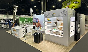 Nehal Naturals completed booth: tiered product shelves around a central reception counter and seating