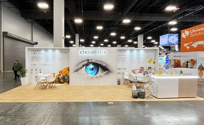 Ennature Biopharma completed booth: a wide graphic back wall behind product displays and meeting tables