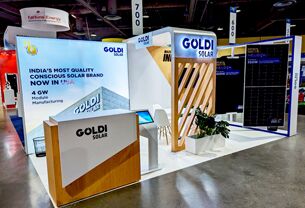 Goldi Solar completed booth: an angled graphic wall beside a solar-panel display and reception counter