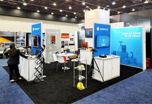 Shining 3D completed booth: a tall central tower and graphic back wall around product-display pedestals