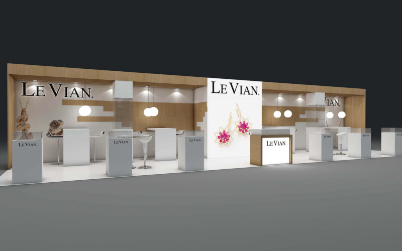 Le Vian booth with wood-effect framing, illuminated jewelry showcases and white reception counters.