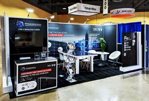Philadelphia Solar completed booth: a corner booth with upright solar panels, a screen and a front counter