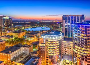 Downtown Orlando buildings and waterfront at dusk